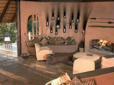 Lounge with fireplace in suite at Garonga Safari Camp - Randocheval / Absolu Voyages